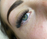 Close-up of stunning pre-made volume eyelash extensions on a woman's eye, showcasing the results of a Volume Eyelash Extension Course.