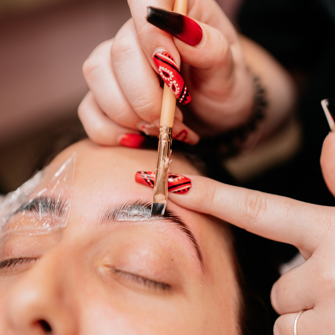 Applying eyebrow wax in a beauty treatment for the Certificate in Professional Beauty Services course.