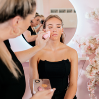 Student receiving professional beauty services application in beauty academy setting
