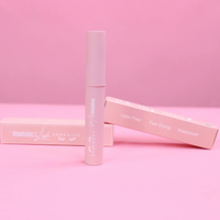Rom Bombshell Lash Adhesive with latex free, fast drying and waterproof features on a pink background.